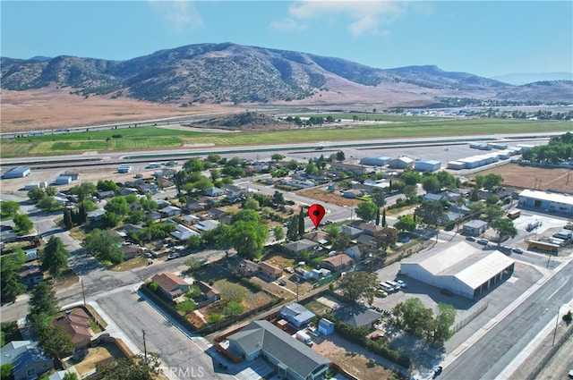 aerial view of property and surrounding area with mountains and nearby suburban area