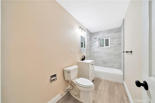 full bathroom with a shower, toilet, a sink, baseboards, and wood finished floors