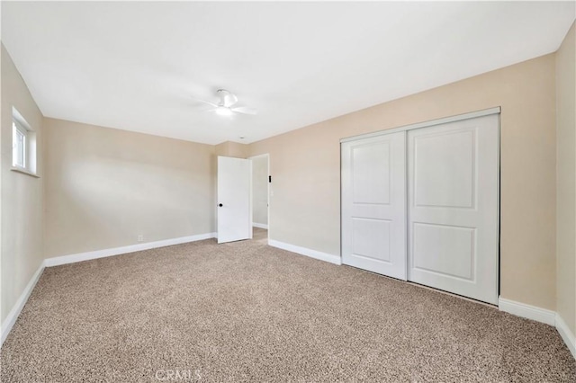 unfurnished bedroom with carpet, baseboards, and a closet