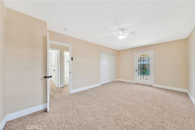 unfurnished bedroom with light carpet, baseboards, a closet, and ceiling fan