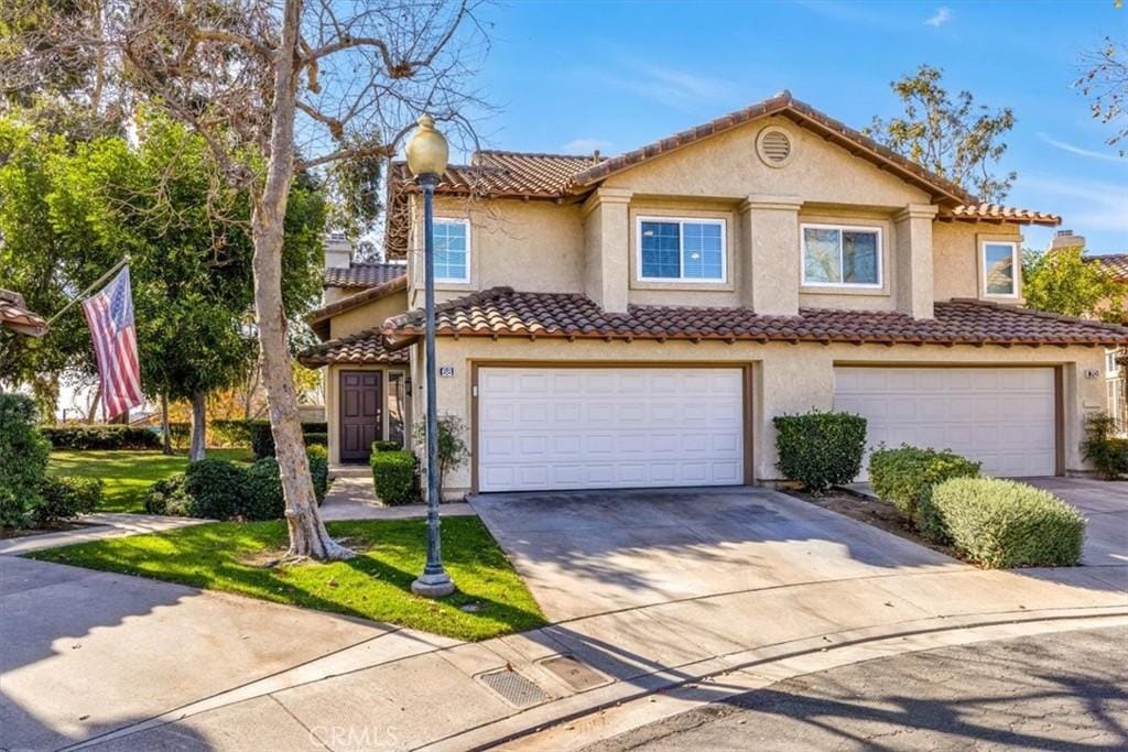 mediterranean / spanish-style home featuring a garage