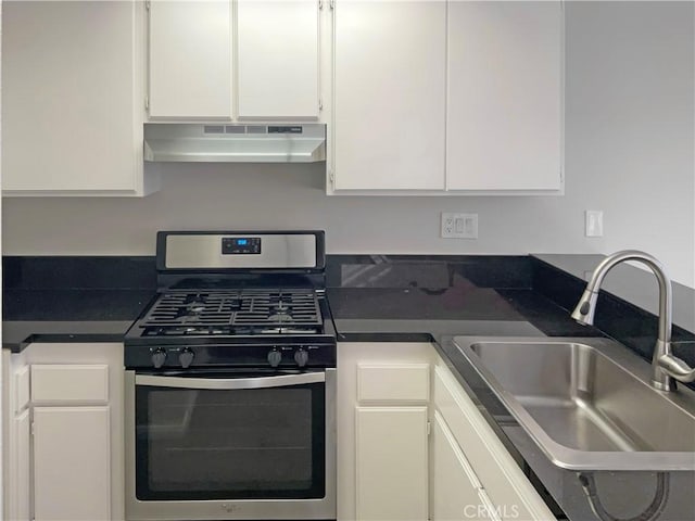 kitchen with stainless steel range with gas stovetop, white cabinets, and sink