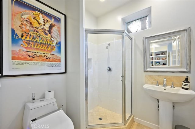 bathroom with sink, an enclosed shower, and toilet