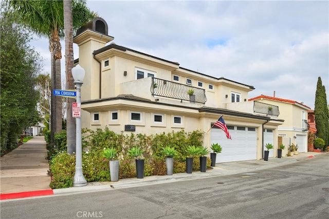 view of front of home with a balcony and a garage