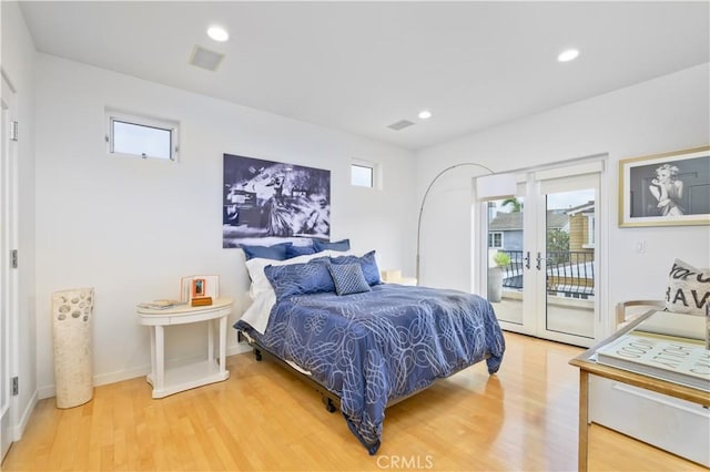 bedroom featuring access to outside, french doors, and light wood-type flooring