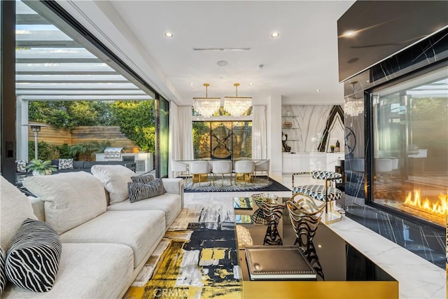 living room with recessed lighting and a glass covered fireplace