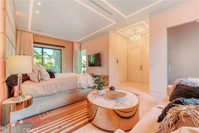 bedroom featuring marble finish floor and a chandelier