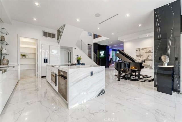 kitchen featuring recessed lighting, visible vents, marble finish floor, and modern cabinets