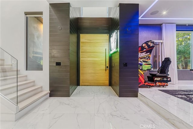 hallway with stairway and marble finish floor