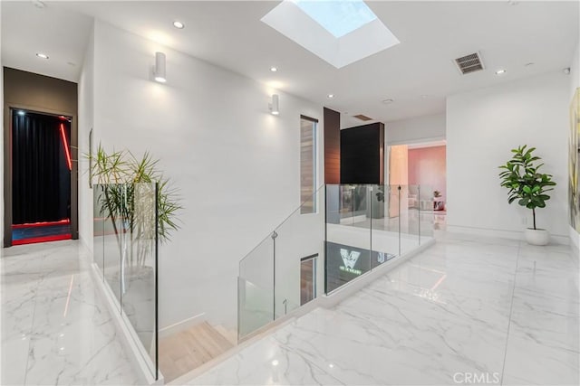 hall with recessed lighting, visible vents, and marble finish floor