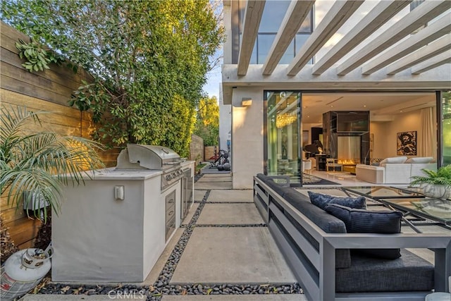 view of patio with an outdoor kitchen, a grill, and an outdoor hangout area