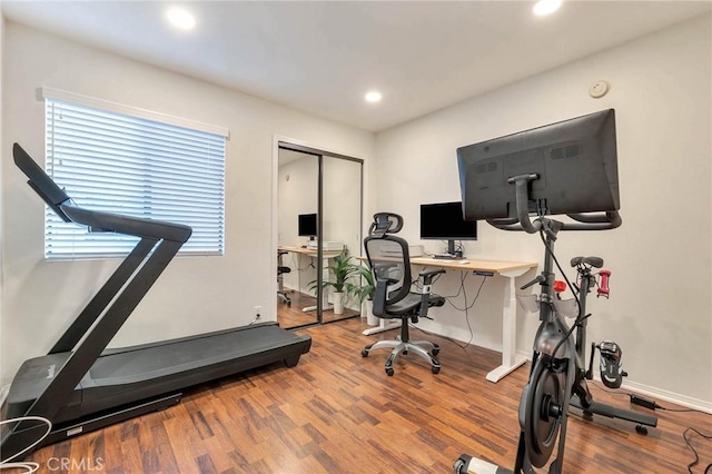 workout area with hardwood / wood-style flooring