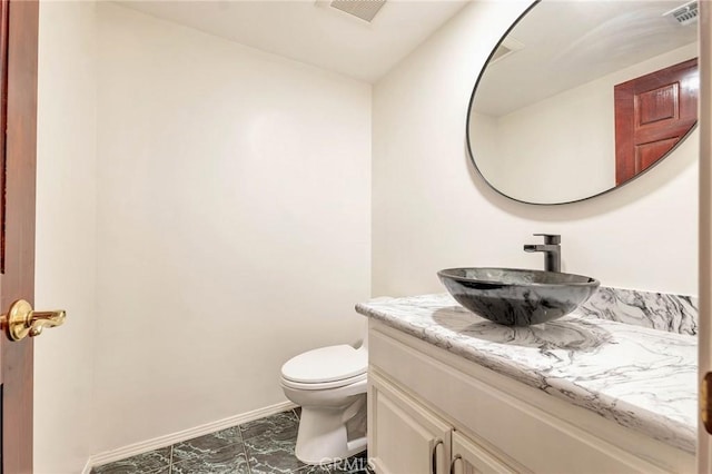 bathroom with toilet and vanity