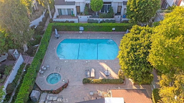 view of swimming pool with a community hot tub