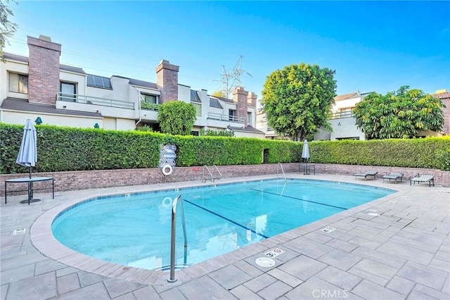 view of swimming pool featuring a patio