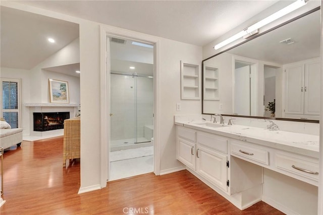 bathroom with hardwood / wood-style floors, an enclosed shower, lofted ceiling, and vanity