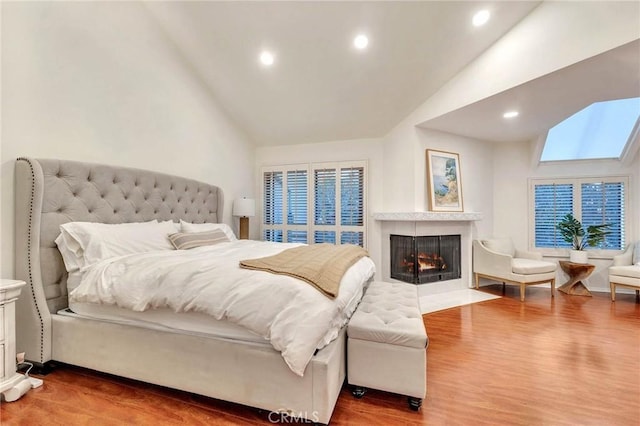 bedroom featuring hardwood / wood-style floors and high vaulted ceiling