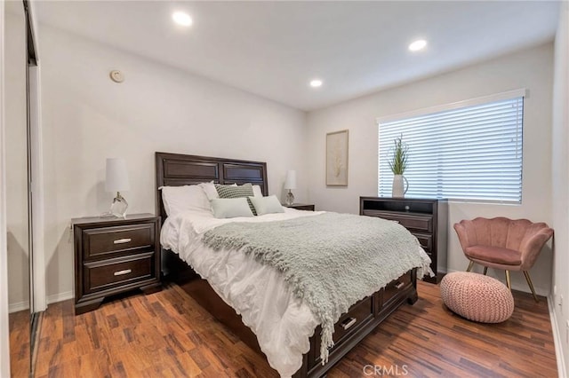 bedroom with dark wood-type flooring