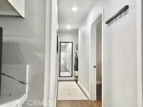 corridor with light wood-type flooring