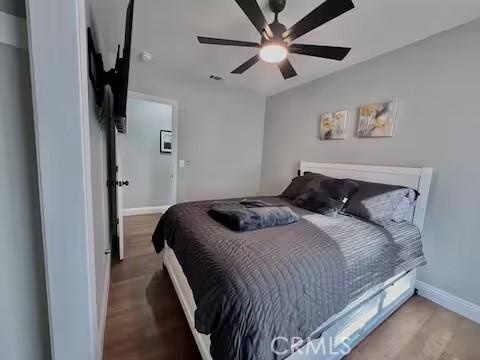 bedroom with hardwood / wood-style flooring and ceiling fan