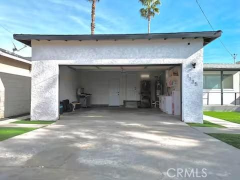 rear view of house featuring a garage