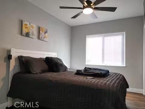 bedroom with ceiling fan and hardwood / wood-style flooring