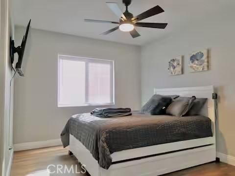 bedroom featuring ceiling fan and hardwood / wood-style flooring