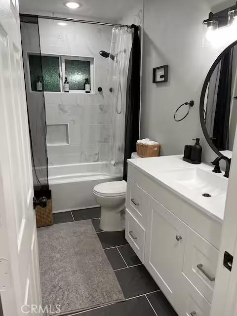 full bathroom with vanity, toilet, tile patterned floors, and shower / tub combo