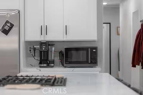 details with white cabinetry and stainless steel appliances