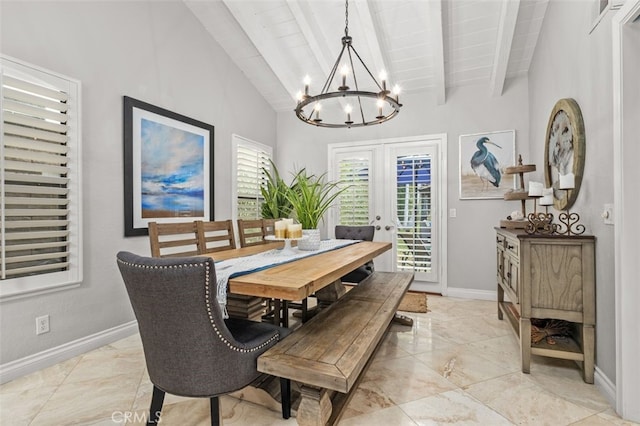 dining space featuring lofted ceiling with beams, a notable chandelier, and french doors