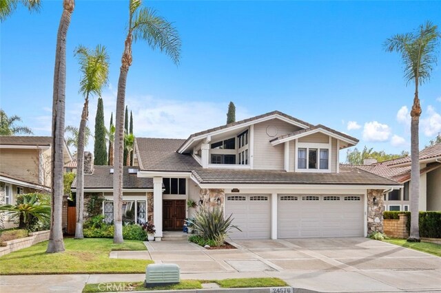 front of property featuring a garage and a front lawn