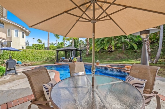 view of pool featuring a gazebo, a patio area, and an in ground hot tub