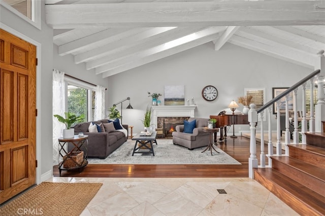 living room featuring vaulted ceiling with beams