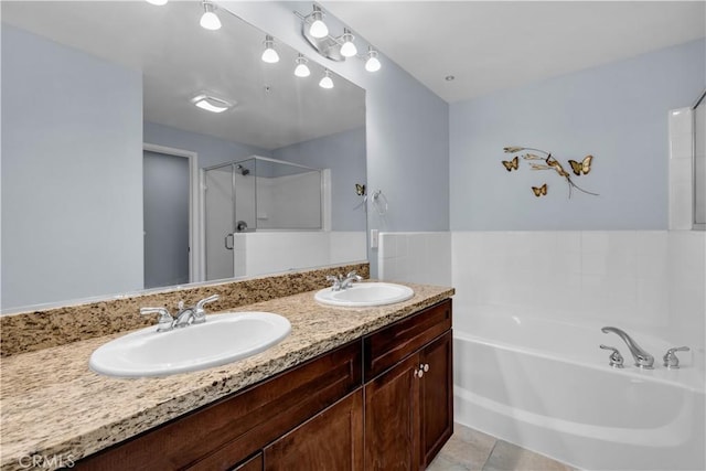 bathroom featuring plus walk in shower, tile patterned floors, and vanity