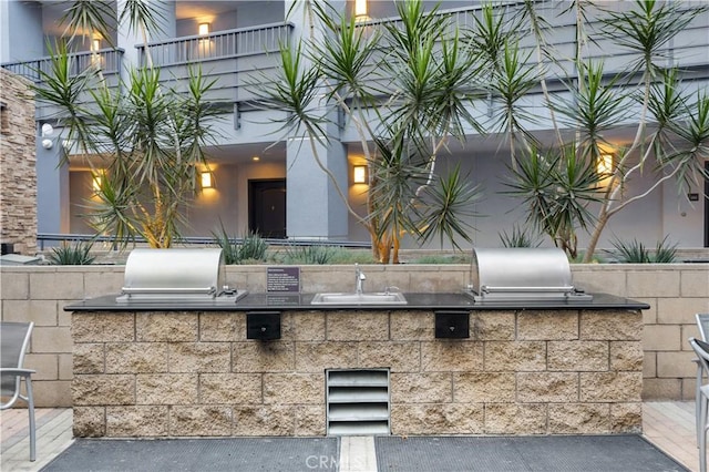 view of patio with sink, an outdoor kitchen, and grilling area