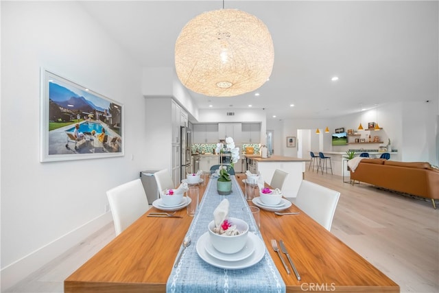 dining space featuring light wood-type flooring