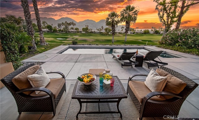 patio terrace at dusk featuring a mountain view and outdoor lounge area