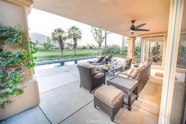 view of patio / terrace featuring a mountain view, ceiling fan, and an outdoor hangout area