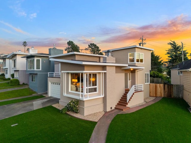 view of front of house with a garage and a yard