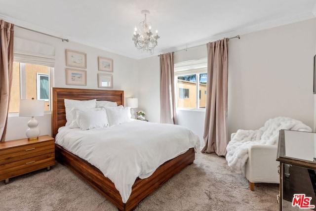 carpeted bedroom featuring crown molding and a chandelier