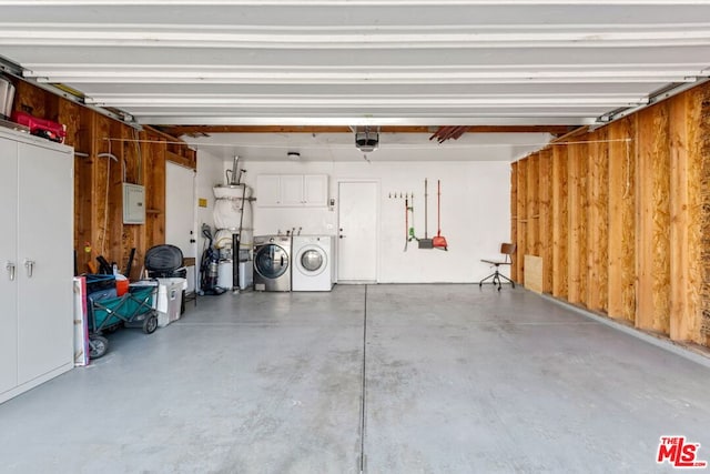 garage with a garage door opener and washer and dryer