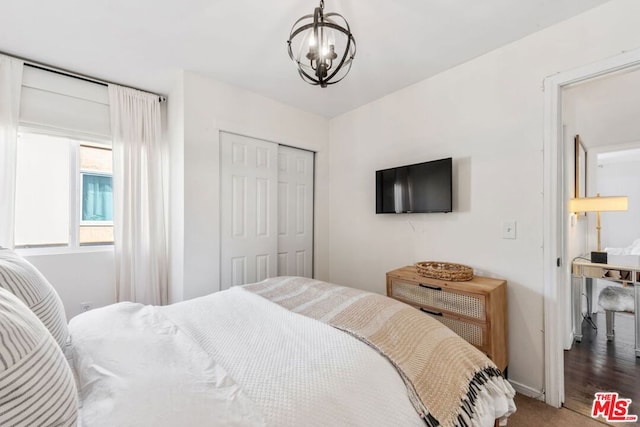 bedroom with a closet and a chandelier