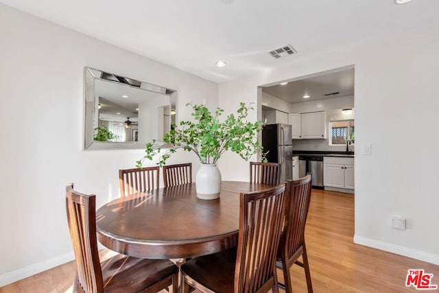 dining room featuring ceiling fan and light hardwood / wood-style flooring