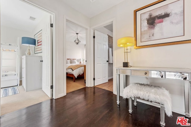 hallway with dark hardwood / wood-style flooring