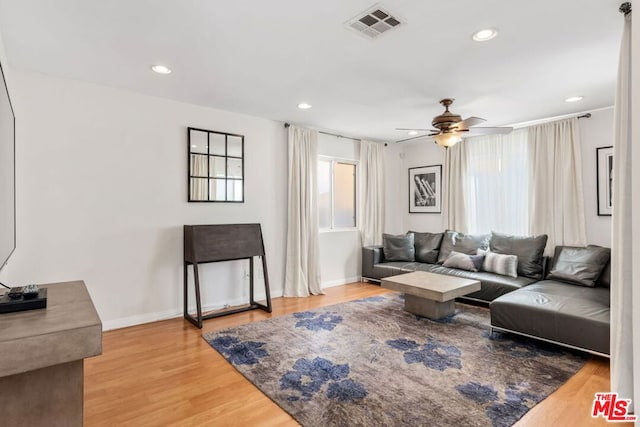 living room featuring hardwood / wood-style floors, a healthy amount of sunlight, and ceiling fan