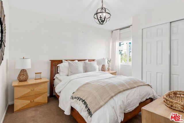 carpeted bedroom featuring a notable chandelier