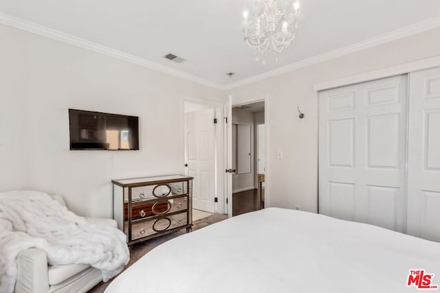 bedroom with a closet, crown molding, and a notable chandelier