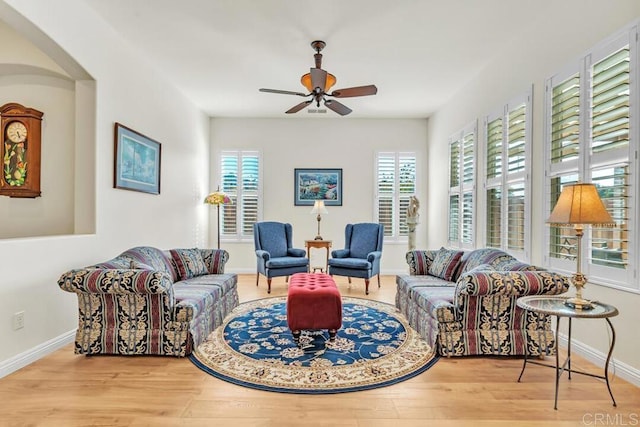 living room with ceiling fan and light hardwood / wood-style floors