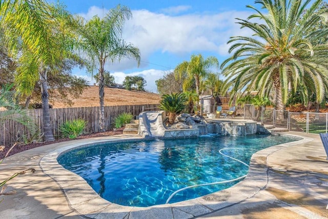 view of swimming pool with a water slide