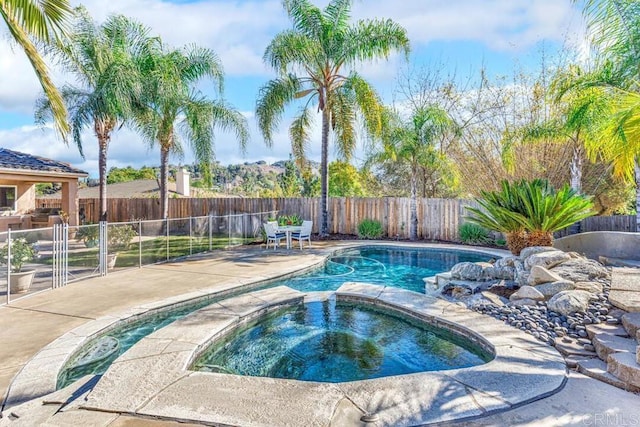 view of pool featuring an in ground hot tub and a patio